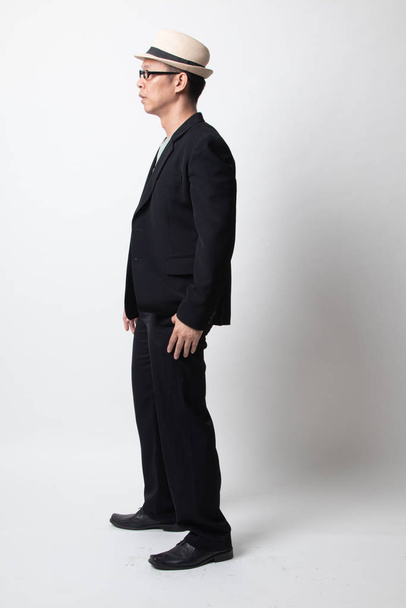 Full body side view of an adult asian man on white background - Foto, afbeelding