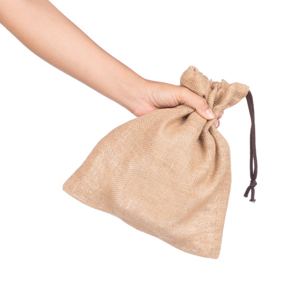 hand holding bag Sackcloth isolated on white background. - Photo, Image