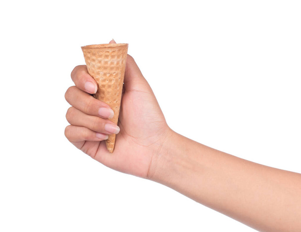 hand holding blank crispy ice cream cone isolated on white background. - Foto, immagini