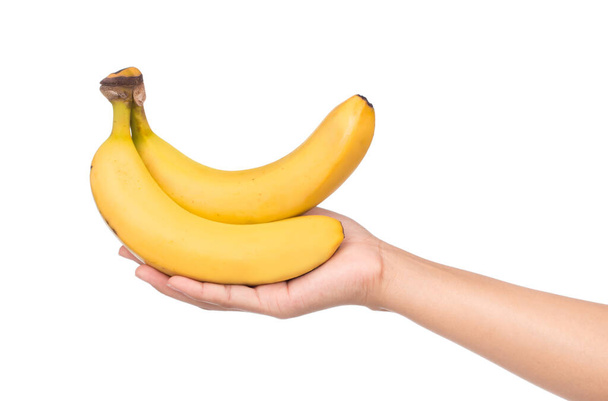 χέρι που κρατά μπανάνας που απομονώνονται σε λευκό φόντο. - Φωτογραφία, εικόνα