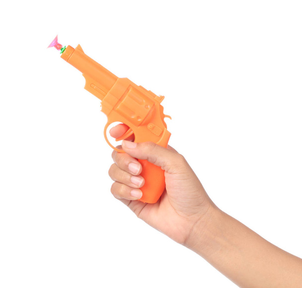 hand holding Toy Gun made of plastic isolated on white background - Photo, Image