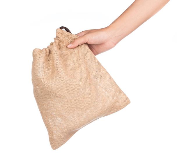 hand holding bag Sackcloth isolated on white background. - Photo, Image