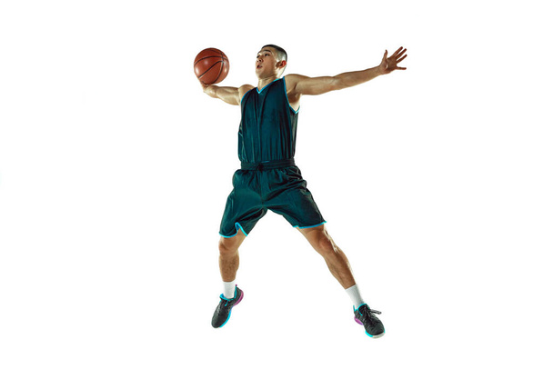 Young basketball player training isolated on white studio background - Foto, afbeelding