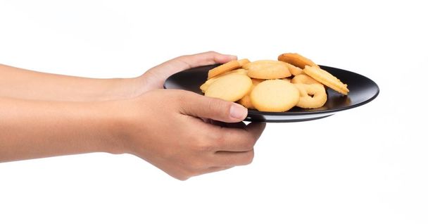 hand holding butter cookies on a dish isolated on white background - Photo, Image