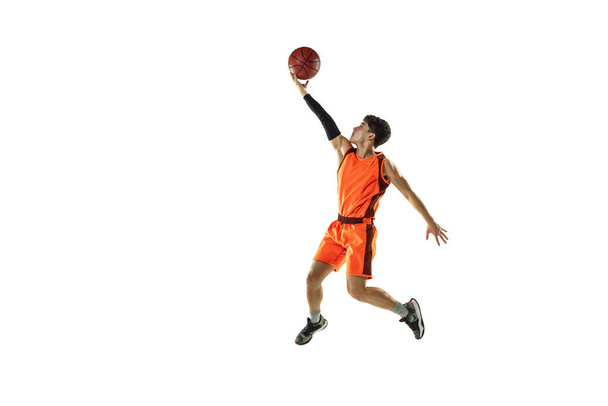 Young basketball player training isolated on white studio background - Foto, Imagem