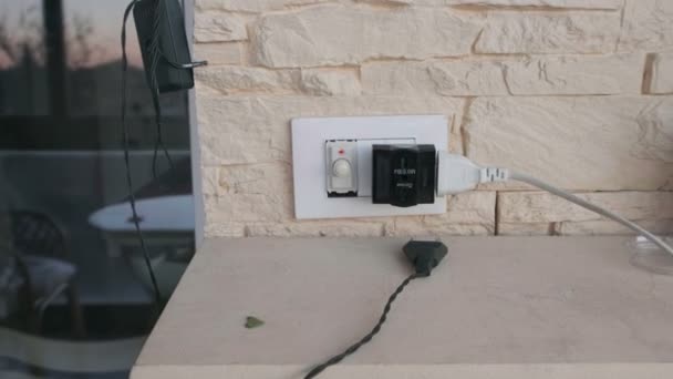 camera come close to an electric plug and multi outlets faster at home with yellow stone brick wall - european sockets  - Footage, Video
