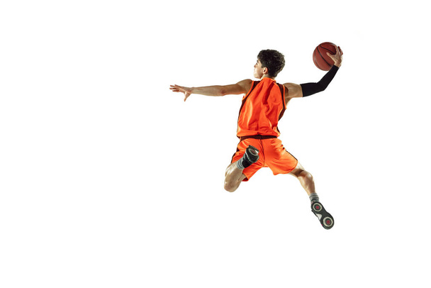 Young basketball player training isolated on white studio background - Фото, зображення