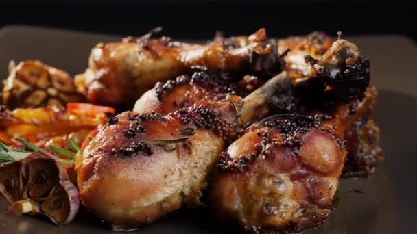 Rotating grilled chicken legs on a plate - Footage, Video
