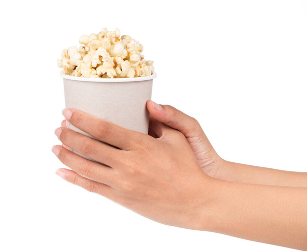 hand holding popcorn in a cup isolated on white background - Φωτογραφία, εικόνα
