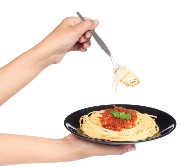 Hand holding fork, eating pasta spaghetti isolated on white background - Photo, Image