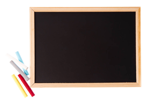 blank blackboard with colored chalks isolated on white background - Photo, Image