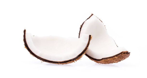 Old brown organic coconut fruit copra broken into pieces and stacked on white background - Photo, Image