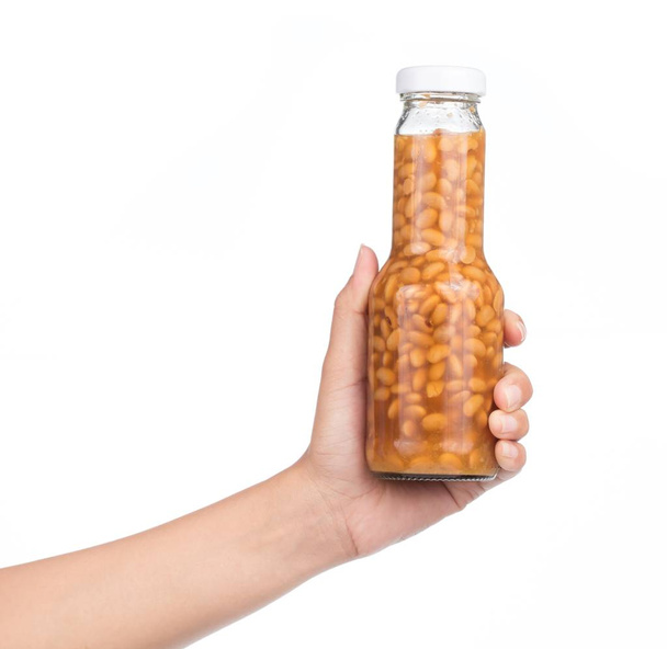 hand holding bottle of salted Soybeans isolate on white background - Φωτογραφία, εικόνα