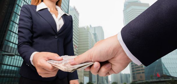 business woman and a businessman hold money - Фото, зображення