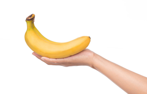 Рука тримає банан ізольовано на білому тлі
. - Фото, зображення