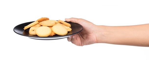 hand holding butter cookies on a dish isolated on white background - Photo, Image
