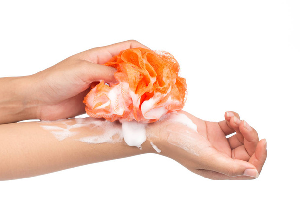 hand holding Soft orange bath puff or sponge isolated on white background - Photo, Image