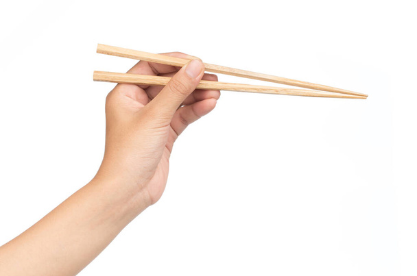 hand holding Wooden chopsticks isolated on white background - 写真・画像