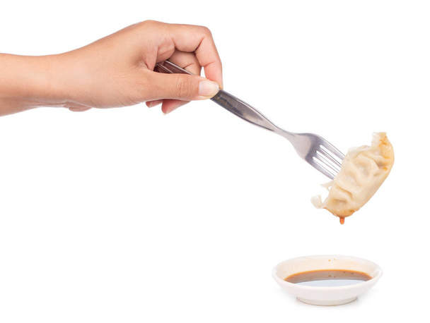 hand holding wonton by fork isolated on white background. - Photo, Image