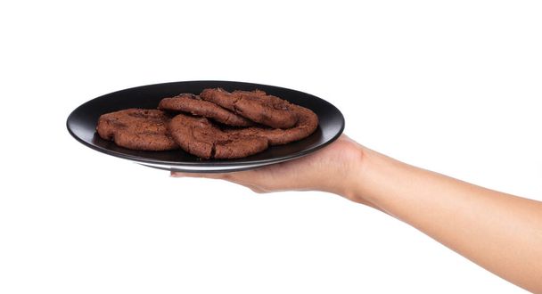 mão segurando Chocolate Chip Cookies no prato isolado no fundo branco
 - Foto, Imagem