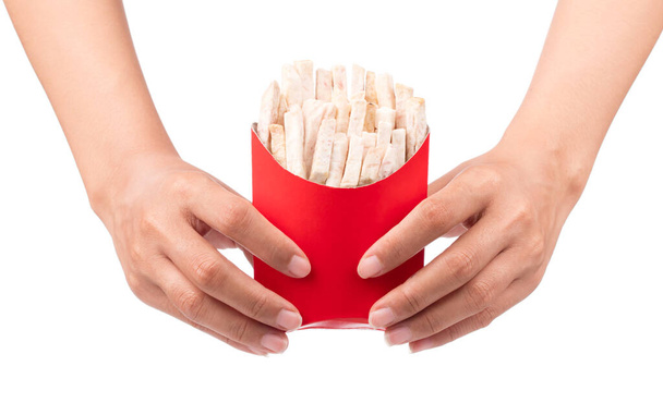 hand holding paper bag of fried taro snacks isolated on white background - Photo, Image