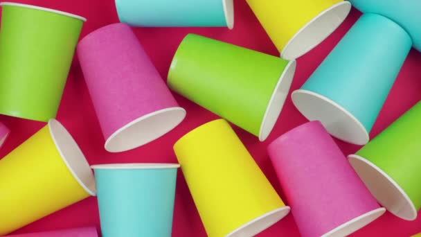Flat lay multicolored paper cups. background Red color - Footage, Video