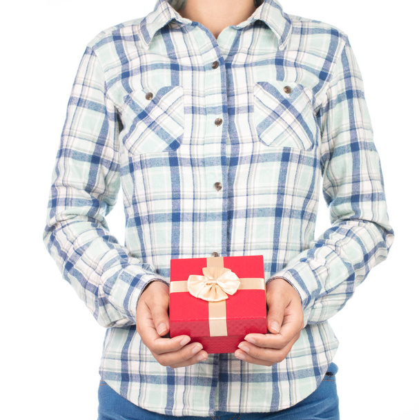 girl dressed in plaid shirt hold gift box in hands. Isolated on white background - Valokuva, kuva