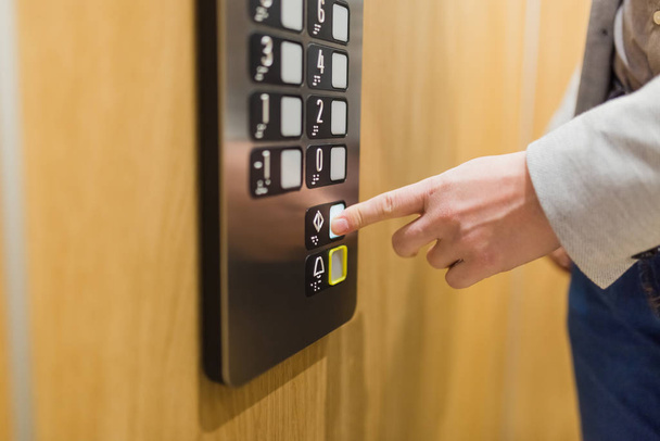 Forefinger pressing door closing button in the elevator. - Foto, imagen