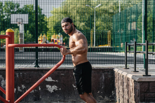 A fitness athlete trains on a sports field. Healthy lifestyle - Φωτογραφία, εικόνα