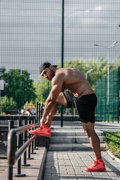 A fitness athlete trains on a sports field. Healthy lifestyle - Fotografie, Obrázek