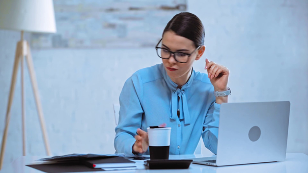 atraktivní podnikatelka pití kávy a pomocí notebooku  - Záběry, video