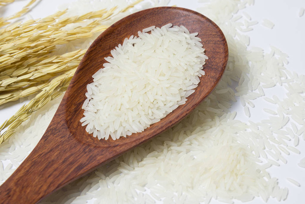 Top view Rice in the wooden spoon put on ear of rice. Health or healthy concept. Food and cooking ingredient. Copy space. - Zdjęcie, obraz