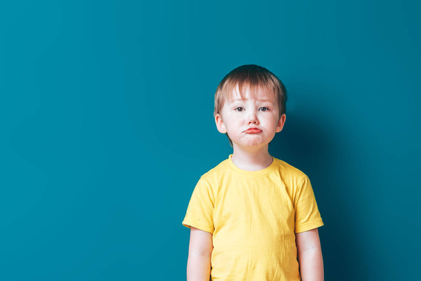 Rozrušit pláč smutný chlapec na modrém pozadí - Fotografie, Obrázek