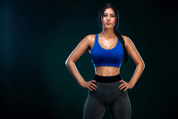 Fit woman athlete, on black background. Fitness and sport motivation. - Fotografie, Obrázek