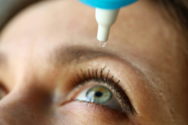 Woman drops eye drops to check vision, prevention - Fotoğraf, Görsel