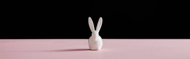 Decorative white bunny isolated on black background, panoramic shot - Zdjęcie, obraz