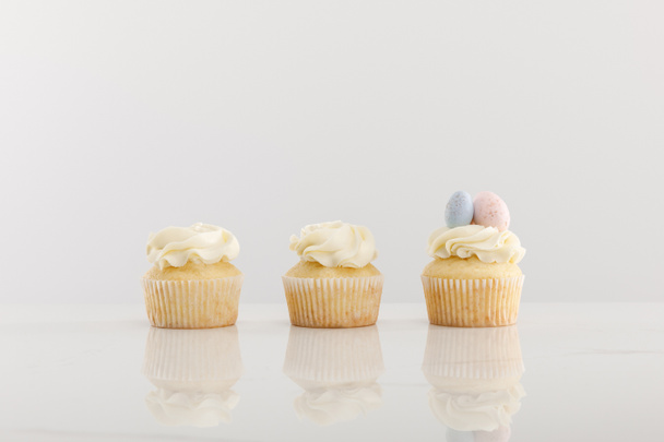 Delicious cupcakes isolated on grey - Photo, Image