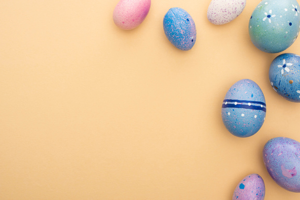 Top view of Easter eggs on beige background - Zdjęcie, obraz