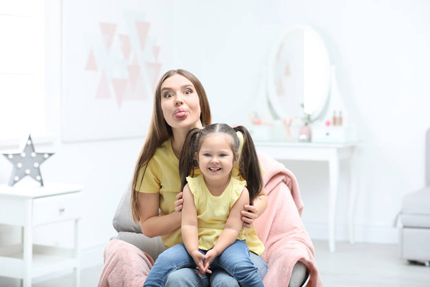 Young mother with little daughter having fun at home - Φωτογραφία, εικόνα