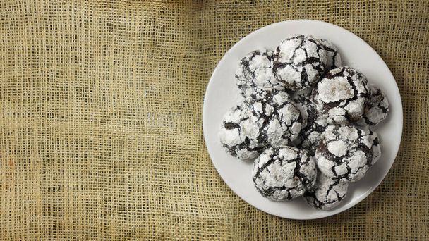 Homemade chocolate cookies. Chocolate brownie cookies in powdered sugar. Selective focus - Photo, Image