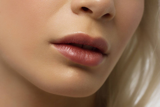 Closeup plump Lips. Lip Care, Augmentation, Fillers. Macro photo with Face detail. Natural shape with perfect contour. Close-up perfect natural lip makeup beautiful female mouth. Plump sexy full lips - Foto, afbeelding