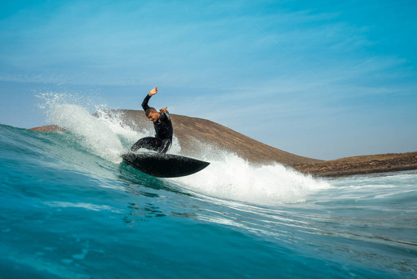 surfer riding waves on the island of fuerteventura - Фото, зображення