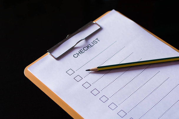 Checklist concept - checklist, papier en een pen met checklist woord op houten tafel - Foto, afbeelding