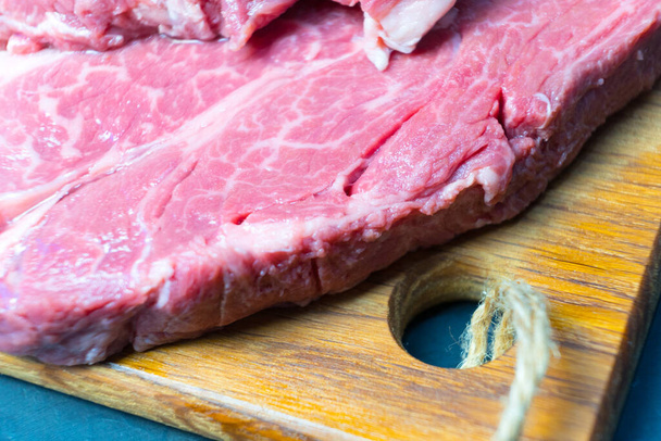 Raw marbled beef steak. Close-up photo on dark background. - Foto, Imagem