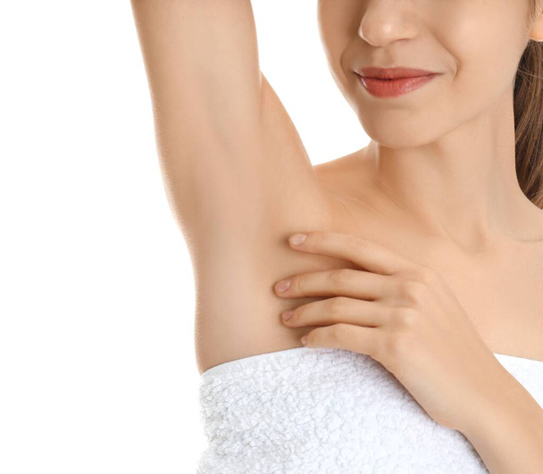 Young woman showing armpit with smooth clean skin on white background, closeup - Photo, image