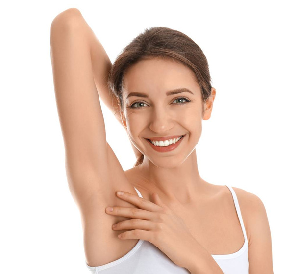 Young woman showing armpit with smooth clean skin on white background - Foto, Imagen