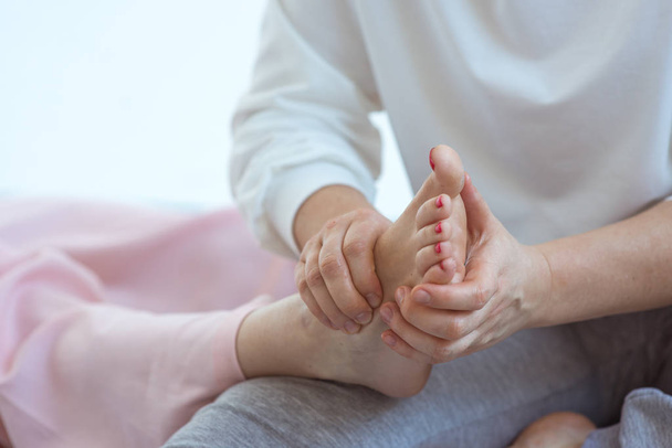 Hand making thai feet massage. Alternative medicine and thai massage concept  - Фото, зображення