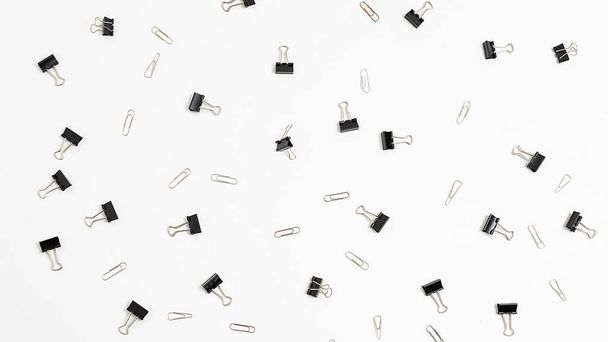 bunch of binder clips randomly scattered on white background. office equipment - Photo, Image