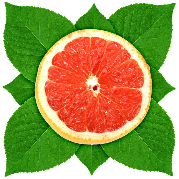 Single cross section of grape-fruit with green leaf - Foto, immagini