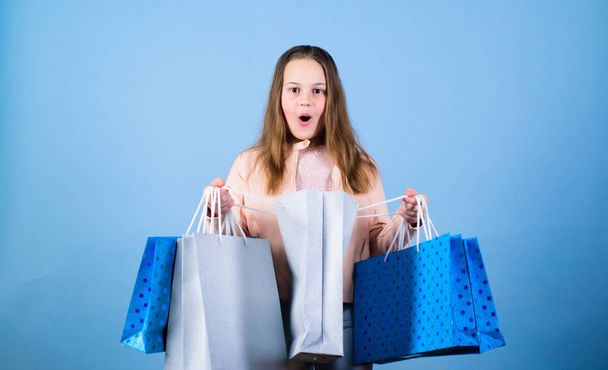Kid fashion. shop assistant with package. Sales and discounts. Small girl with shopping bags. Happy child. Little girl with gifts. Holiday purchase saving. Choosing the best. feeling a surprise - Photo, Image
